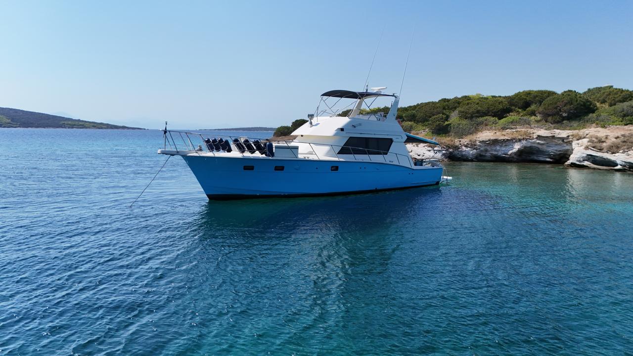 Production boat anchored in a Greek bay