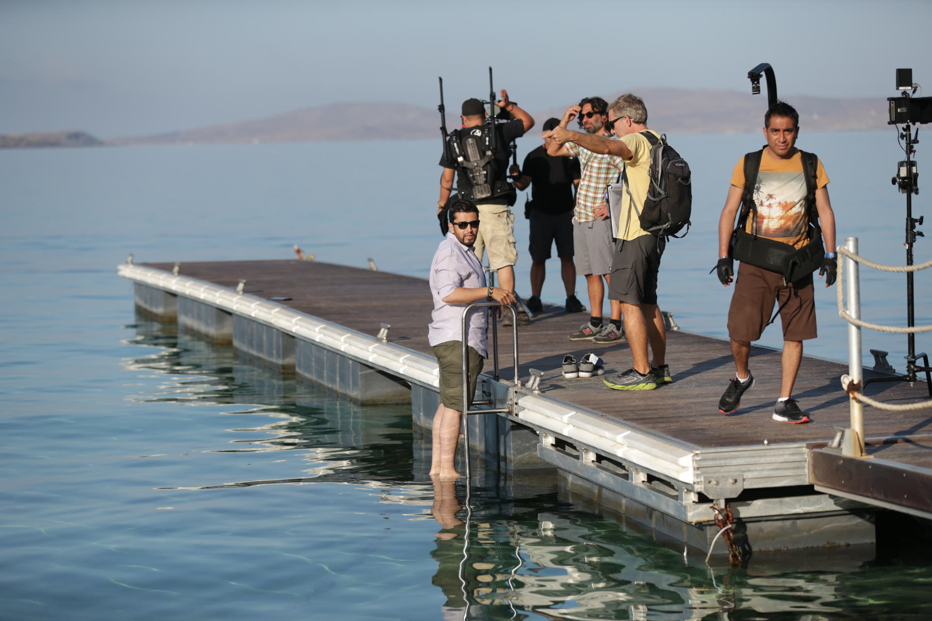 Production crew preparing a scene on the waterfront set