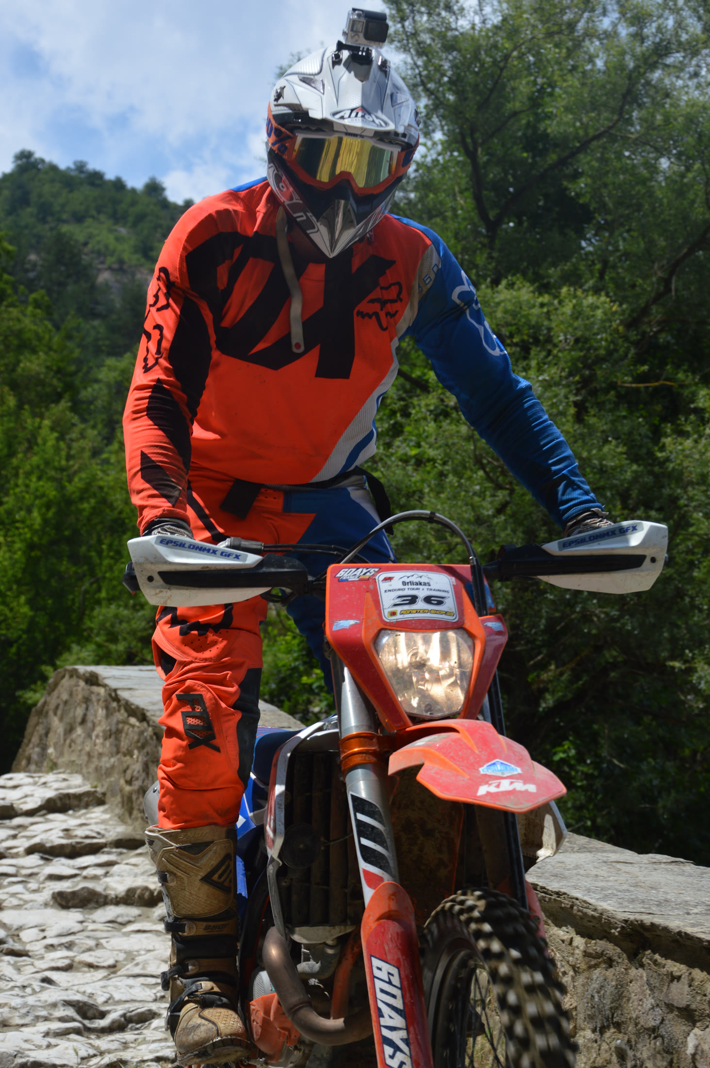 Motorcycle rider crossing the stone bridge during the Grevena race