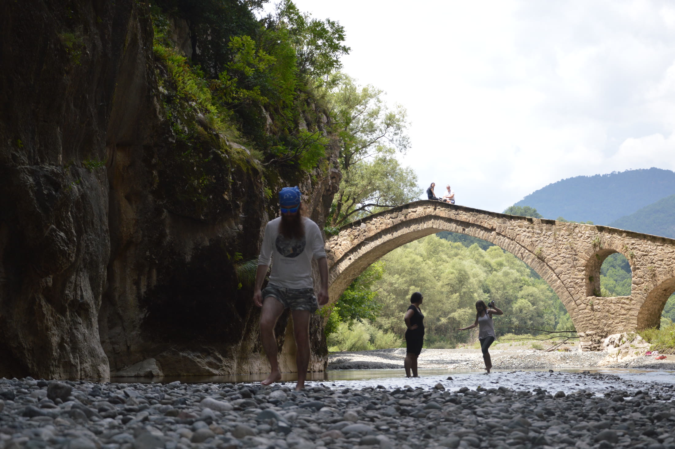 Production location beside a historic bridge and mountain gorge in Grevena