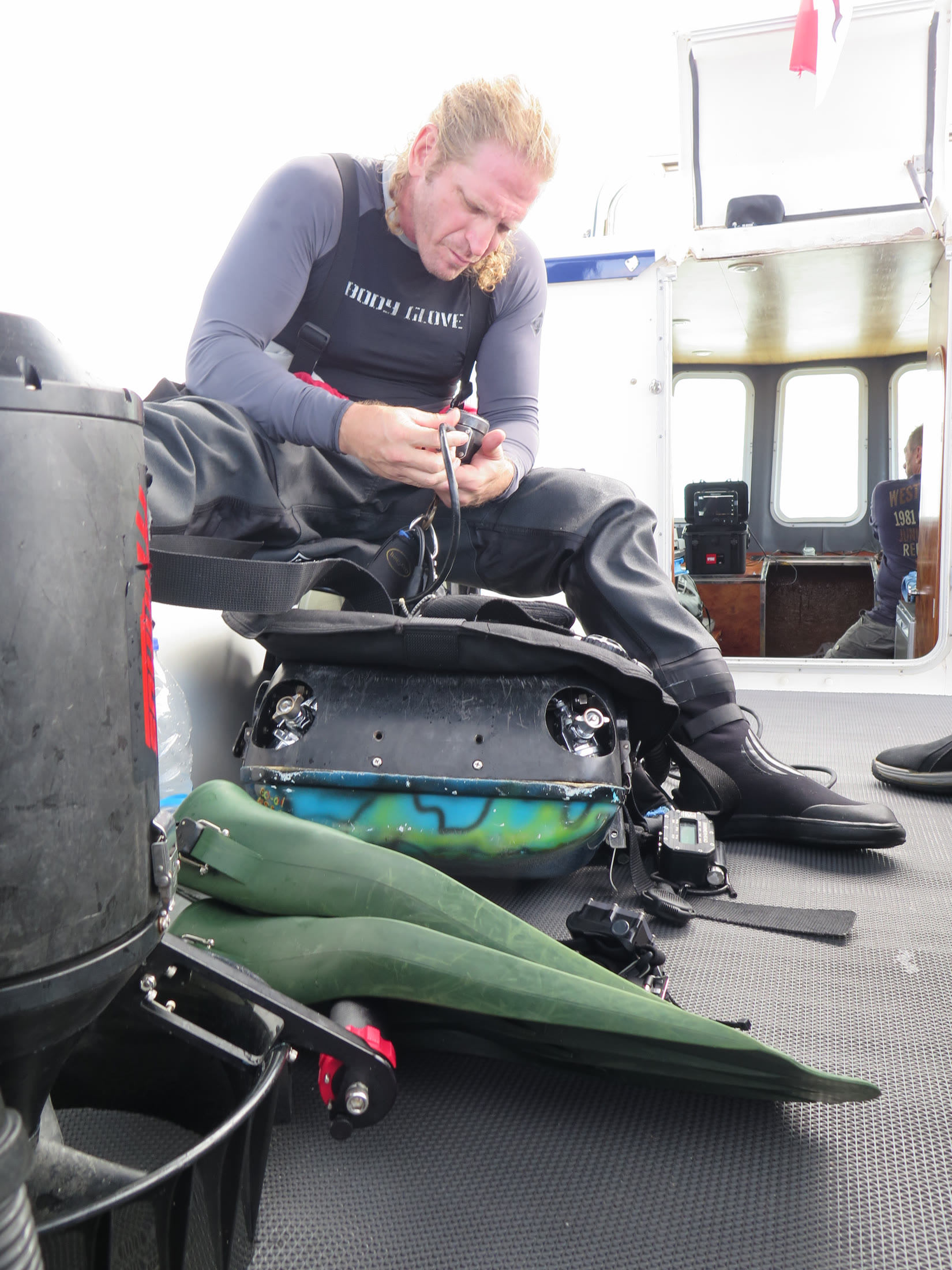 Diver preparing underwater filming equipment on the support vessel