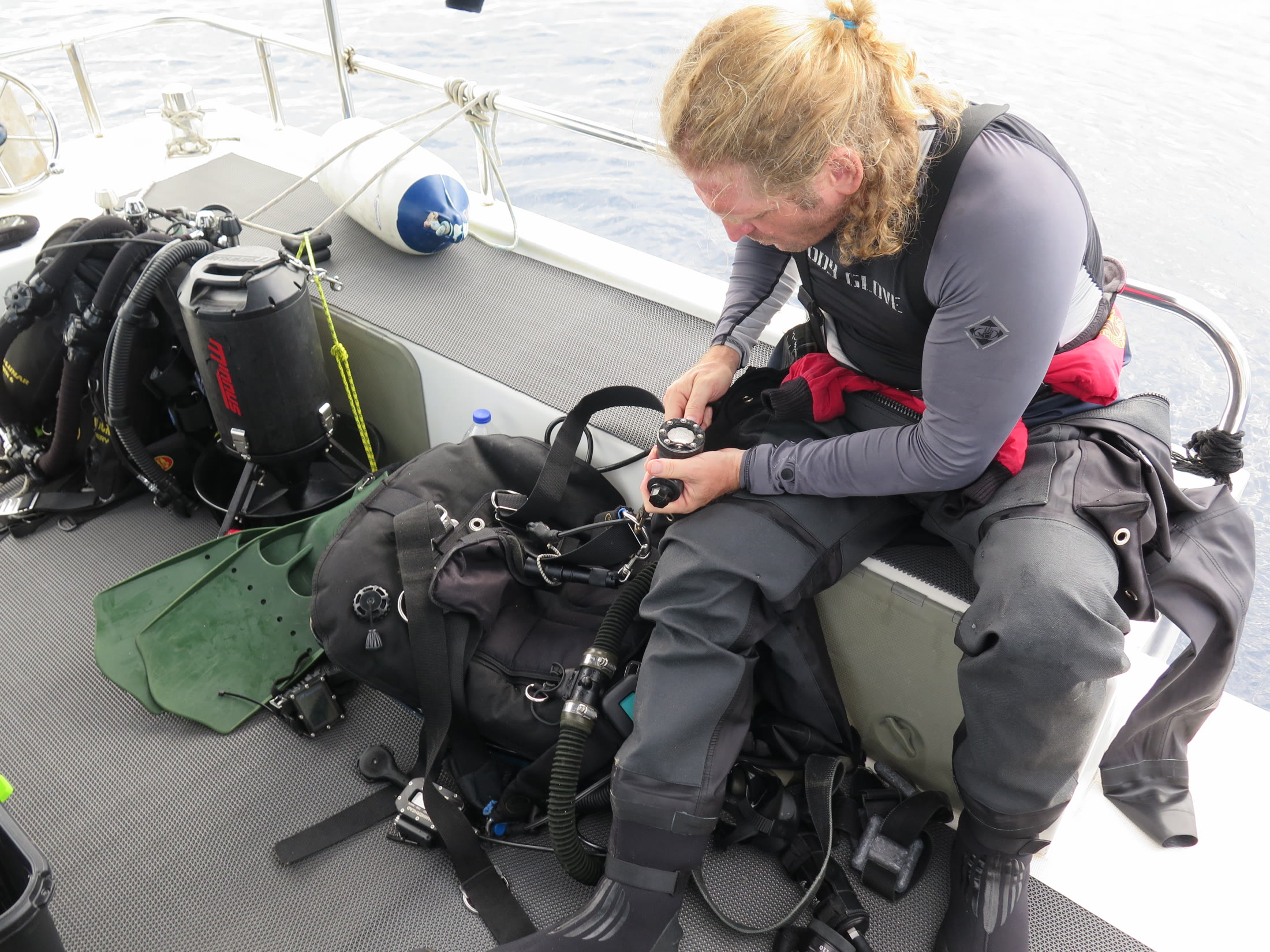 Diver checking technical scuba equipment aboard the support boat